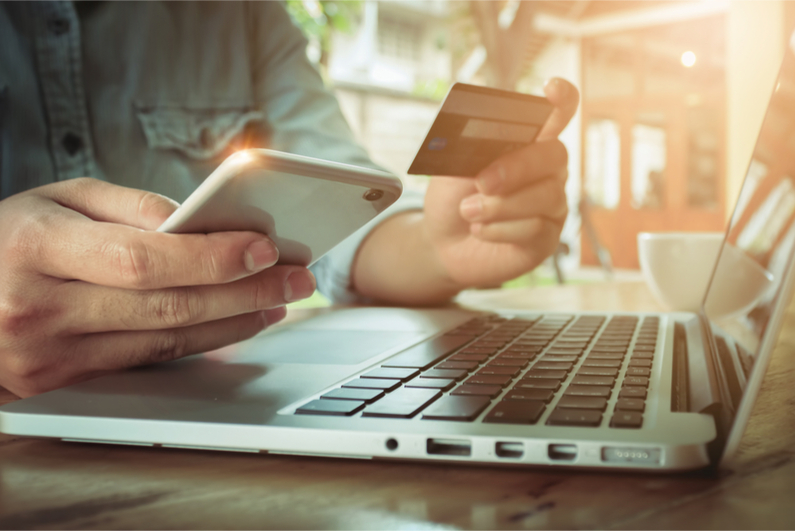 Online payment,Man's hands holding smartphone and using credit card