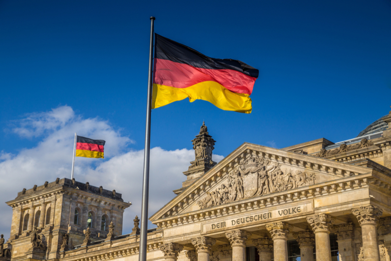 German flag waving in front of Reichstag building