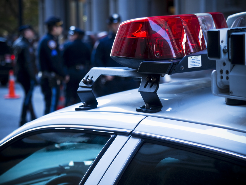 police car siren lights with police officers in the background