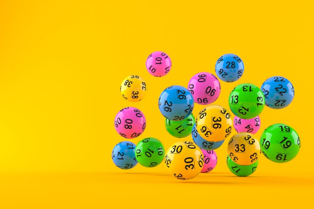 colored lottery balls against an orange backdrop