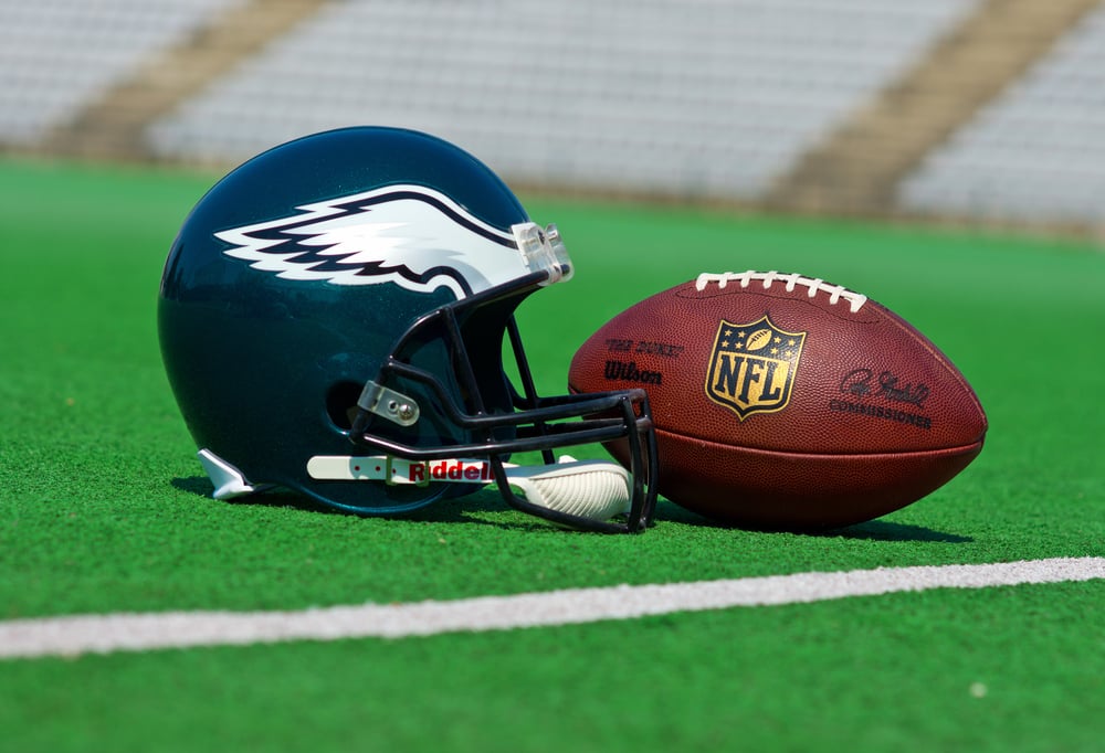 Philadelphia Eagles helmet and football on green pitch