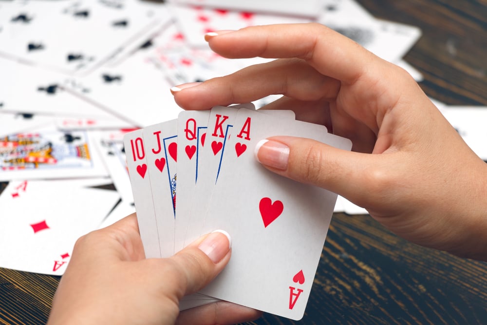 female hands holding best poker hand