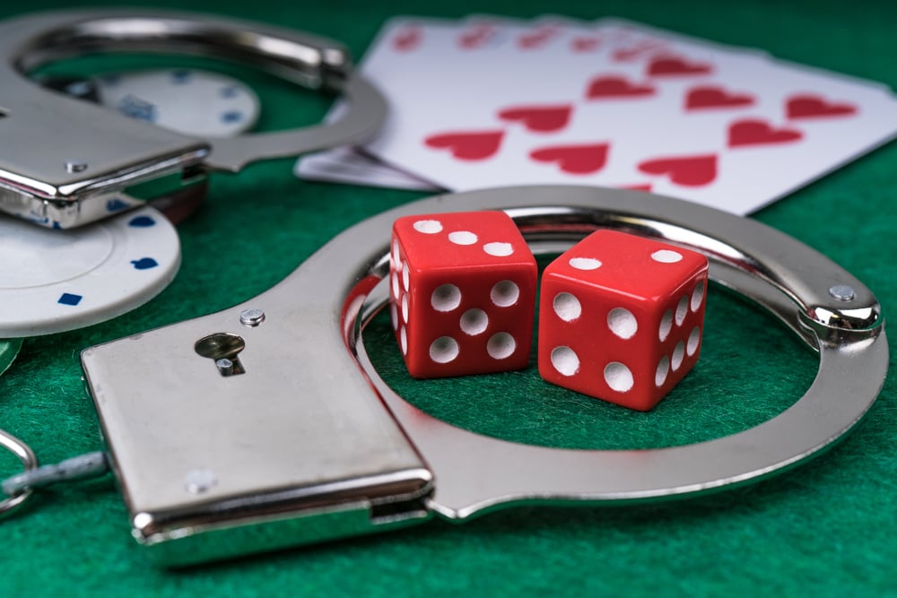 Handcuffs and dice with playing cards