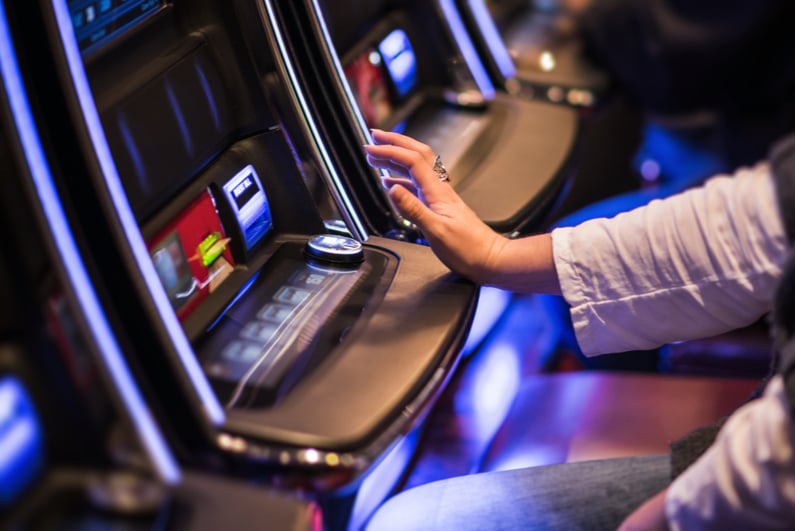 Person playing poker machine